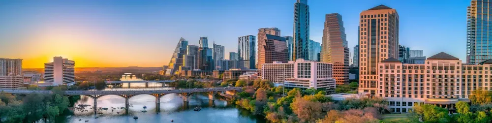 Austin, Texas- Panoramic cityscape and Colorado River against the sunset sky
